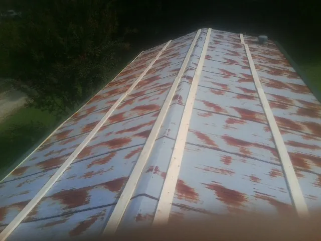 Rusted metal roof panels with new wood purlins before replacement — Storm Damage Roof Repair in Raywood by Roofing Brothers
