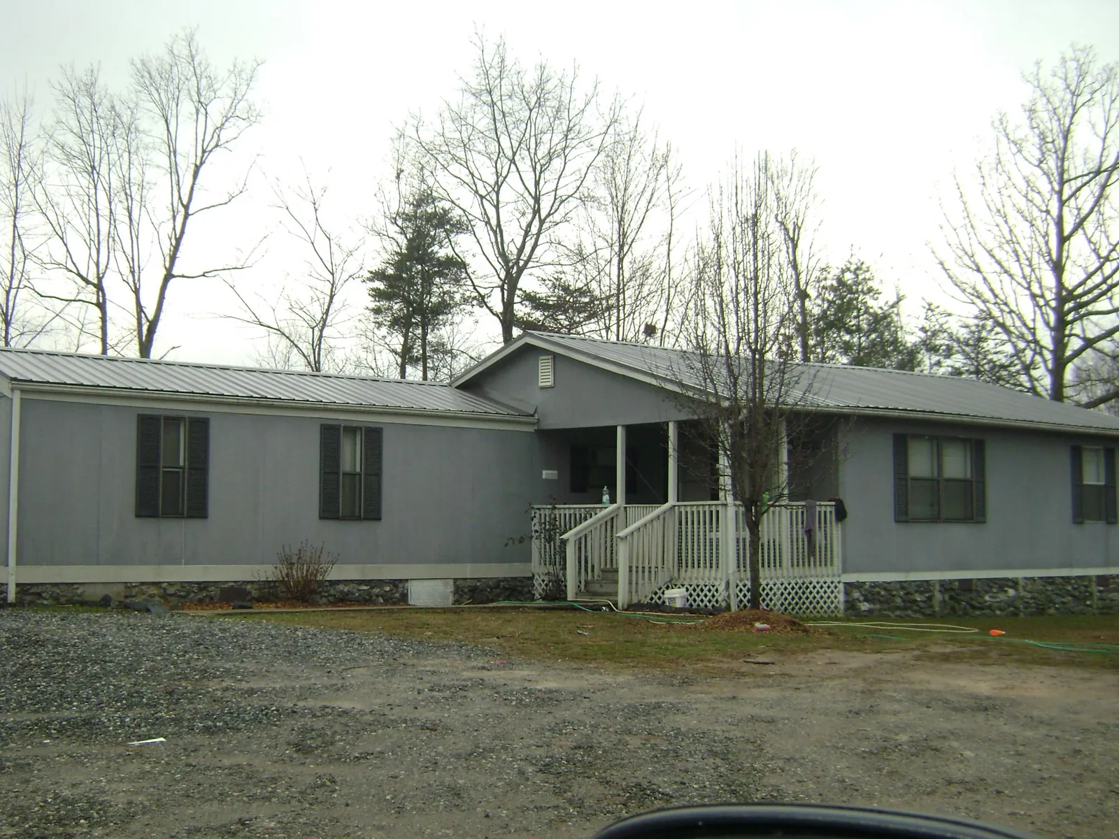 Metal roof over a manufactured home with a covered front porch in Raywood