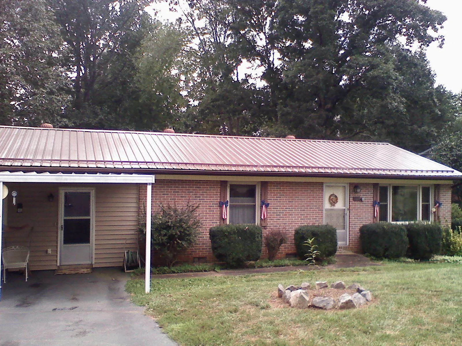 Bronze metal roof and carport on a brick ranch home — Roof Repair work by our crew in Raywood